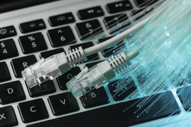 blue-optic-fiber-with-ethernet-cables-and-laptop