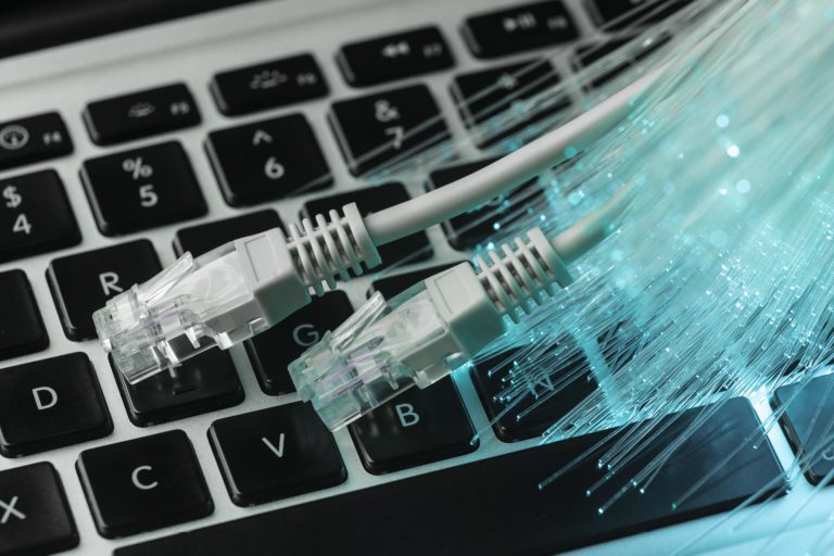 blue-optic-fiber-with-ethernet-cables-and-laptop